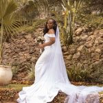 Sleeveless white mermaid wedding dress with off shoulder sleeves.