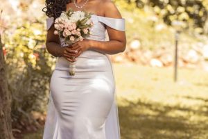 Sleeveless white mermaid wedding dress with off shoulder sleeves.